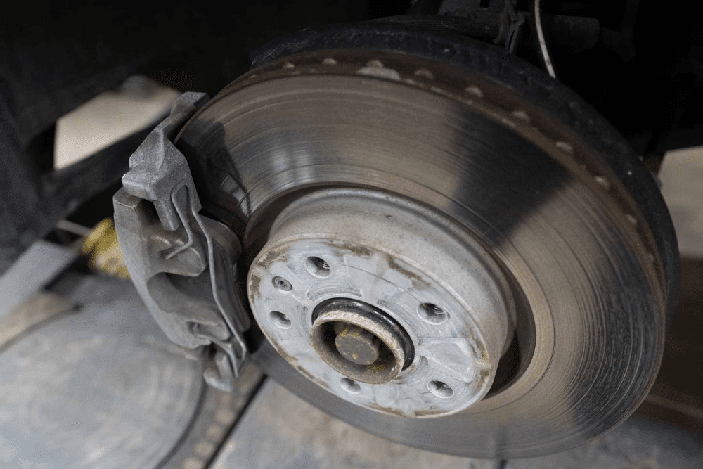 brake rotor replacement, auto repair in Lonsdale, MN at Lonsdale Auto Works. Close-up view of a car brake system consists of brake disc, caliper, and rotor.