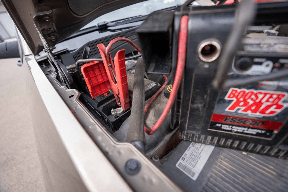 Battery and alternator diagnostics in Lonsdale, MN by Lonsdale Auto Works. Image of a technician testing a vehicle battery and alternator in a professional auto repair shop.